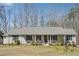 Charming single-story home featuring a cozy front porch, gray siding and well-maintained landscaping at 9991 Holly Hill Way, Jonesboro, GA 30238