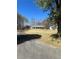 Expansive front yard with mature trees and a long driveway leading to the charming home at 9991 Holly Hill Way, Jonesboro, GA 30238