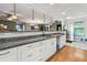 Modern kitchen featuring granite countertops, white cabinetry and a stainless steel refrigerator at 9991 Holly Hill Way, Jonesboro, GA 30238