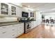 Bright kitchen featuring white cabinets, granite countertops, stainless steel appliances, and hardwood floors at 9991 Holly Hill Way, Jonesboro, GA 30238