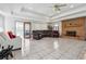 Large living room with tile floors, coffered ceilings, brick fireplace and an attached sun room at 9991 Holly Hill Way, Jonesboro, GA 30238