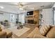 Relaxing living room with brick fireplace, TV, hardwood floors, and neutral furniture at 9991 Holly Hill Way, Jonesboro, GA 30238