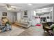 A relaxing living room with wood floors, gray paint, and an open layout to the kitchen at 9991 Holly Hill Way, Jonesboro, GA 30238