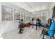 Bright sunroom featuring tile floors, many windows, and exercise equipment at 9991 Holly Hill Way, Jonesboro, GA 30238