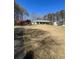 Large lot featuring a charming home, garages, and mature trees lining the long paved driveway at 9991 Holly Hill Way, Jonesboro, GA 30238