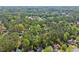 Aerial view of a neighborhood with homes surrounded by mature trees and lush greenery at 10070 Timberstone Rd, Johns Creek, GA 30022