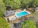 Community pool view from above, featuring a large pool, splash fountain, and ample seating areas at 10070 Timberstone Rd, Johns Creek, GA 30022