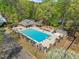 An aerial shot shows a community pool with diving board, chairs, and umbrellas for the residents at 10070 Timberstone Rd, Johns Creek, GA 30022