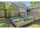 A serene backyard features a garden bed with a patio, providing a tranquil outdoor space at 10070 Timberstone Rd, Johns Creek, GA 30022