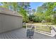 A backyard deck featuring wood-look flooring, a cozy seating area, and a view of the lawn at 10070 Timberstone Rd, Johns Creek, GA 30022