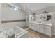 Bright bathroom boasts double sinks, skylights, soaking tub, and a glass shower at 10070 Timberstone Rd, Johns Creek, GA 30022