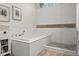 Luxurious bathroom featuring a soaking tub with white tile surround and pebble flooring at 10070 Timberstone Rd, Johns Creek, GA 30022