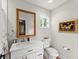 Bright bathroom featuring a toilet, framed mirror, and modern vanity sink at 10070 Timberstone Rd, Johns Creek, GA 30022