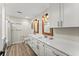 Bright bathroom with a double vanity, lots of cabinets, modern lighting, and wood-look flooring at 10070 Timberstone Rd, Johns Creek, GA 30022