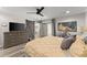 Comfortable bedroom features a ceiling fan, barn door, and dresser with mounted television at 10070 Timberstone Rd, Johns Creek, GA 30022
