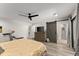 Spacious bedroom features a ceiling fan, barn door, and gray wood flooring at 10070 Timberstone Rd, Johns Creek, GA 30022