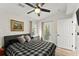 Comfortable bedroom featuring a bed, stylish furnishings, access to the outside, and a sunny window at 10070 Timberstone Rd, Johns Creek, GA 30022