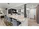 Modern kitchen featuring an island with seating, stainless appliances, and an adjacent sliding barn door at 10070 Timberstone Rd, Johns Creek, GA 30022