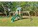 Backyard playground featuring a swing set, slide, climbing ladder and playhouse at 10070 Timberstone Rd, Johns Creek, GA 30022