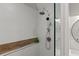 Shower featuring a rain shower head and a wood accent panel with a shelf for products at 10070 Timberstone Rd, Johns Creek, GA 30022