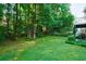 Lush backyard offering privacy, green grass and mature trees at 1192 Lake Washington Dr, Lawrenceville, GA 30043