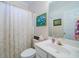 Cozy bathroom with a vanity, toilet and shower with a patterned curtain at 1192 Lake Washington Dr, Lawrenceville, GA 30043