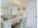 Elegant bathroom vanity featuring a spacious countertop, decorative chair and plenty of storage space at 1192 Lake Washington Dr, Lawrenceville, GA 30043
