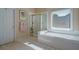 Bathroom featuring a shower and tub combination with white tile plus a large window for natural light at 1192 Lake Washington Dr, Lawrenceville, GA 30043