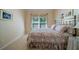 Comfortable bedroom features a floral comforter, natural light, and neutral tones at 1192 Lake Washington Dr, Lawrenceville, GA 30043