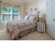 Cozy bedroom with a floral comforter, bright window, and decorative side table at 1192 Lake Washington Dr, Lawrenceville, GA 30043