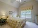 Comfortable bedroom with bright window, floral bedding, and ceiling fan at 1192 Lake Washington Dr, Lawrenceville, GA 30043