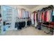 Spacious walk-in closet with ample storage, shelving and hanging space for clothing and shoes at 1192 Lake Washington Dr, Lawrenceville, GA 30043