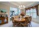 Bright dining room with an adjacent doorway and elegant wood furniture at 1192 Lake Washington Dr, Lawrenceville, GA 30043
