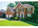 Charming brick two-story home with manicured front lawn and a two-car garage at 1192 Lake Washington Dr, Lawrenceville, GA 30043