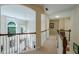 An open hallway with white railing, beige carpet, and natural light from the window at 1192 Lake Washington Dr, Lawrenceville, GA 30043