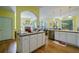 Yellow kitchen with stainless steel appliances, wooden floors, and an eat-in area at 1192 Lake Washington Dr, Lawrenceville, GA 30043