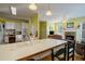 Open kitchen featuring an island with a sink and a view into the adjacent living area with a stone fireplace at 1192 Lake Washington Dr, Lawrenceville, GA 30043