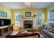 Cozy living room features a stone fireplace, comfortable seating, and lots of windows at 1192 Lake Washington Dr, Lawrenceville, GA 30043