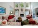 Bright living room featuring a fireplace, large windows and comfortable couches with patterned pillows at 1192 Lake Washington Dr, Lawrenceville, GA 30043