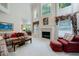 Spacious living room with a fireplace, large windows, and comfortable seating arrangement at 1192 Lake Washington Dr, Lawrenceville, GA 30043