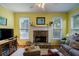 Cozy living room features a stone fireplace, plush seating, and plenty of natural light at 1192 Lake Washington Dr, Lawrenceville, GA 30043