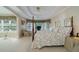 Bright main bedroom with a tray ceiling, natural light, a seating area, and a four-poster bed at 1192 Lake Washington Dr, Lawrenceville, GA 30043