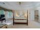 The main bedroom features a tray ceiling, soft carpet, natural light, and a stairway to another level at 1192 Lake Washington Dr, Lawrenceville, GA 30043