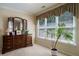Sitting room with a dark wood dresser and mirror plus large windows providing natural light at 1192 Lake Washington Dr, Lawrenceville, GA 30043