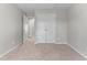 A bedroom with neutral paint, carpet, a double door closet and a second door leading to the hallway at 7045 Threadstone Overlook, Johns Creek, GA 30097