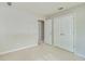 Neutral bedroom features a double door closet and tan carpet at 7045 Threadstone Overlook, Johns Creek, GA 30097