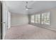 Spacious bedroom with a ceiling fan and windows offering natural light at 7045 Threadstone Overlook, Johns Creek, GA 30097