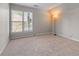This bedroom features neutral paint, carpet and a window letting in natural light at 7045 Threadstone Overlook, Johns Creek, GA 30097