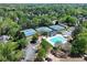 Aerial view of community amenities, including a pool, tennis courts, playground and parking lot at 7045 Threadstone Overlook, Johns Creek, GA 30097