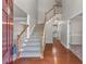 Inviting entryway showcasing hardwood floors, a staircase, and an open floor plan at 7045 Threadstone Overlook, Johns Creek, GA 30097